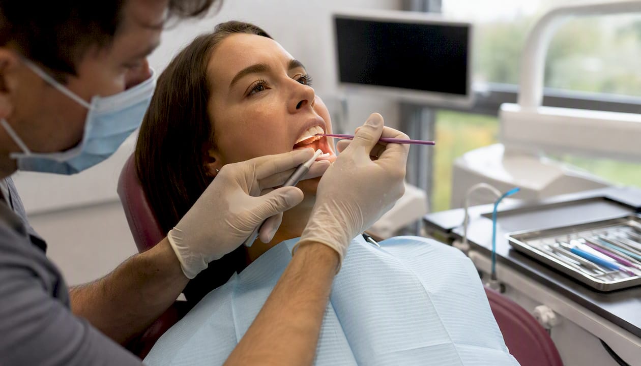 Dentist applying cosmetic bonding on tooth