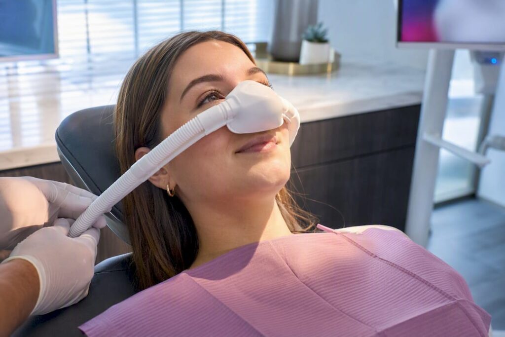 Patient receiving nitrous oxide through nasal hood