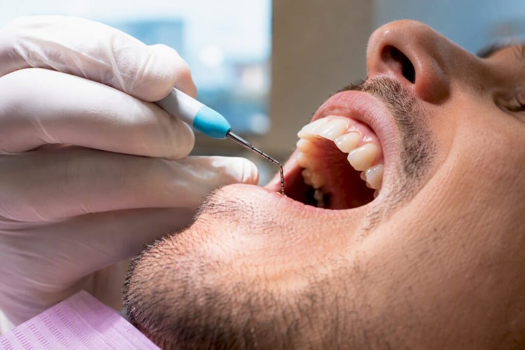 Periodontist measuring gum pocket depth